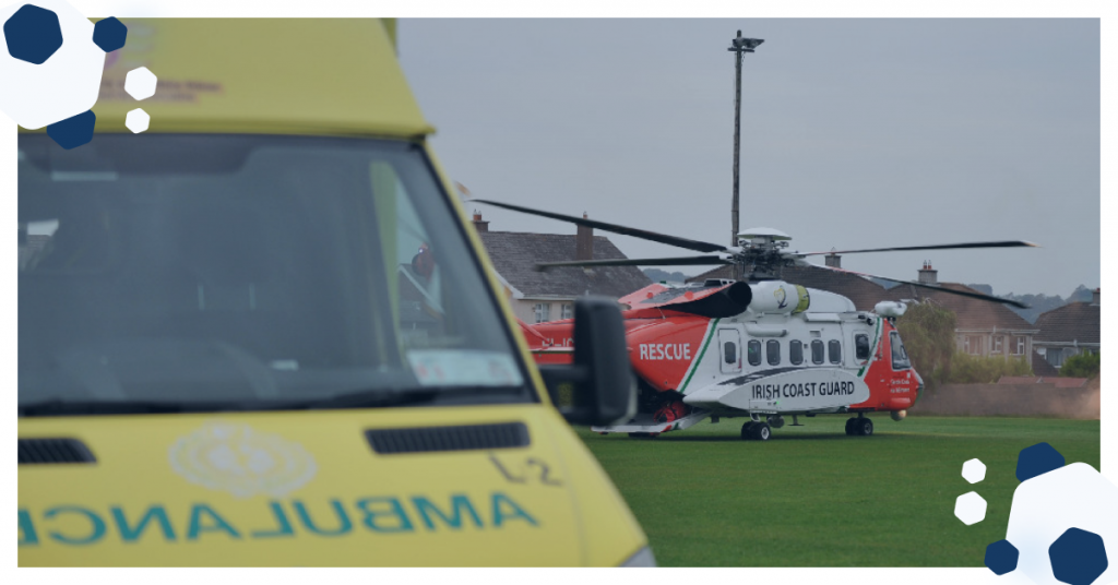 image showing an ambulance in the foreground and a coast guard helicopter in the near distance